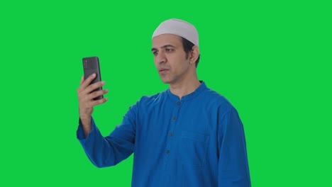 Muslim-man-talking-on-video-call-Green-screen