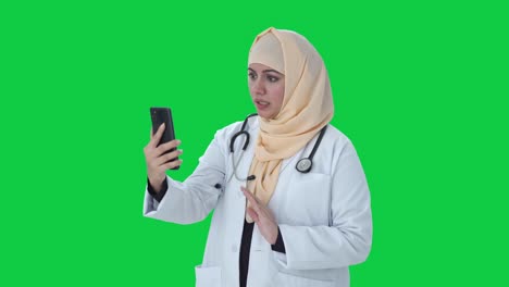 Muslim-doctor-talking-on-video-call-Green-screen