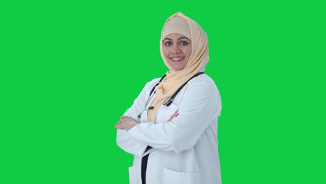 Portrait-of-Happy-Muslim-doctor-standing-crossed-hands-Green-screen