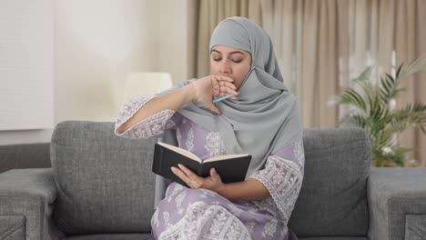 Schläfrige-Muslimische-Frau,-Die-Ein-Tagebuch-Schreibt