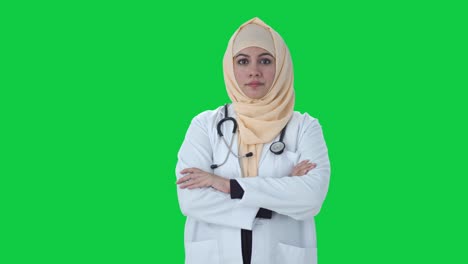 Confident-Muslim-doctor-standing-crossed-hands-Green-screen
