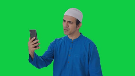 Angry-Muslim-man-talking-on-video-call-Green-screen