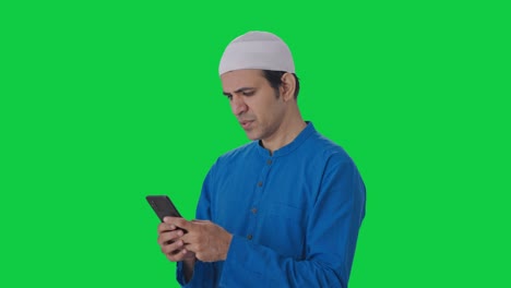 Ernsthafter-Muslimischer-Mann-Chattet-Auf-Dem-Grünen-Bildschirm-Des-Telefons