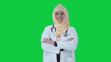 Glücklicher-Muslimischer-Arzt,-Der-Mit-Gekreuzten-Händen-Auf-Grünem-Bildschirm-Steht