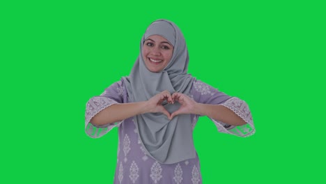 Happy-Muslim-woman-showing-heart-sign-Green-screen