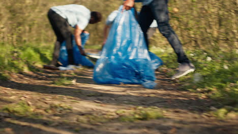 People-picking-up-trash-and-plastic-bottles-from-the-forest-area