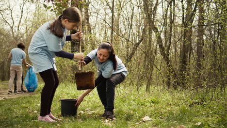 Mother-and-daughter-team-up-to-plant-new-trees-in-the-woods