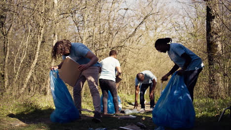 Team-of-volunteers-collecting-rubbish-to-fix-pollution-problem-within-the-forest-habitat