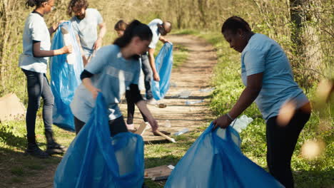 Diverse-group-of-activists-gathering-to-clean-up-a-forest-area