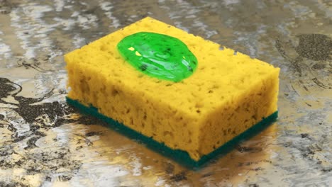 Close-up-shot-of-green-dish-soap-being-squeezed-onto-a-yellow-sponge-placed-on-a-rusted-metal-kitchen-surface.-Dishwashing-liquid-detergent-is-poured-on-a-dish-scrub-in-clean-macro-shot.