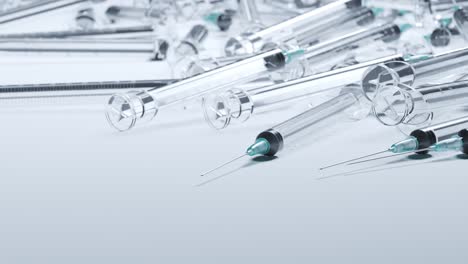 A-pile-of-used-generic-plastic-disposable-syringes.-Medical-waste.-Empty-clear-plastic-syringes.-Close-up-on-the-needle.-Concept-of-health,-medication,-drug-addiction,-diabetes,-vaccination.-4K