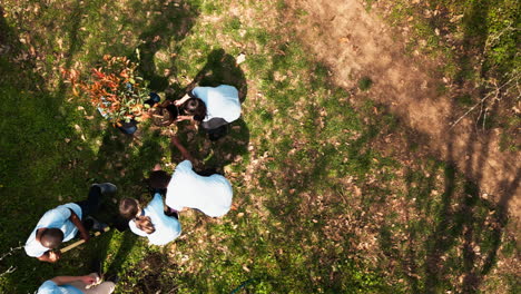 Drone-shot-of-volunteers-group-planting-trees-and-preserving-nature