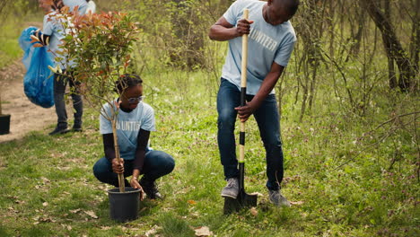 Team-of-activists-planting-trees-to-conserve-natural-ecosystem-and-forest