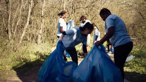Diverse-group-of-activists-gathering-to-clean-up-a-forest-area