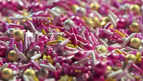 Closeup-animation-of-countless-colorful-sugar-sprinkles-stacked-in-an-endless-loop.-Soft-light-illuminates-candy-details.-Delicious-and-beautiful-cake-dessert-decoration.-Perfect-treat-for-kids.