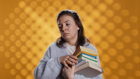 Exhausted-woman-yawning,-holding-heavy-stack-of-books-needed-for-school-exam