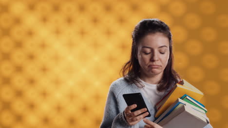 Upset-woman-holding-stack-of-book,-preparing-for-school-exam-using-phone