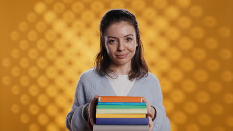 Portrait-of-friendly-woman-offering-stack-of-textbooks-useful-for-school