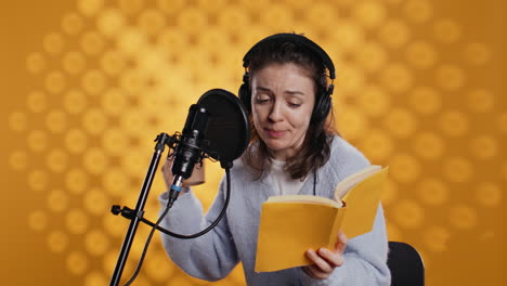 Voice-actor-reads-book-while-enjoying-coffee,-recording-audiobook