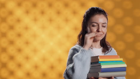 Portrait-of-stern-woman-holding-stack-of-books-doing-stop-sign-gesturing