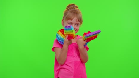 Girl-hiding-behind-many-pop-it-sensory-anti-stress-toys,-squishy-bubbles-trendy-game,-anti-stress