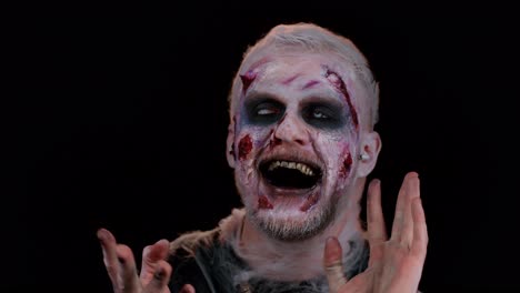 Frightening-man-with-Halloween-zombie-make-up-wearing-earphones,-listening-music-dancing-celebrating