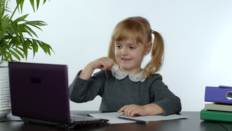 Preschool-child-girl-distance-online-learning-at-home.-Kid-studying-using-digital-laptop-computer
