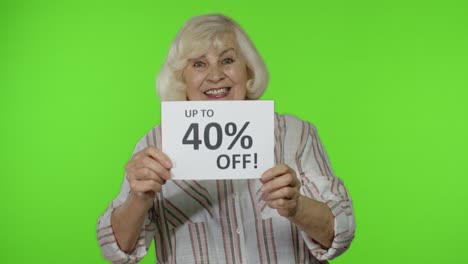 Senior-grandmother-showing-Up-To-40-percent-Off-inscription-sign,-rejoicing-discounts,-low-prices