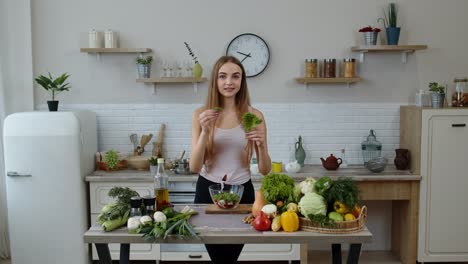 Girl-throwing-pieces-of-lettuce-on-plate,-telling-the-recipe.-Cooking-salad-with-raw-vegetables