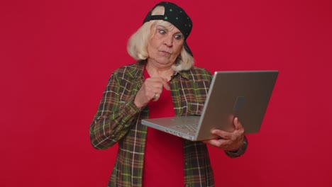 Glückliche-ältere-Frau-Tippt-Am-Laptop,-Arbeitet-An-Einem-Projekt,-Freut-Sich-über-Die-Ergebnisse,-Gewinnt-Im-Lotto