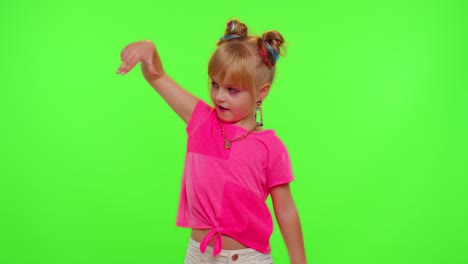 Joyful-little-kid-girl-blogger-front-of-phone-camera-record-video-enjoy-dance-content-on-chroma-key
