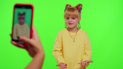 Dancing-young-little-kid-girl-blogger-record-dance-moves-at-camera-for-social-media-content-on-phone