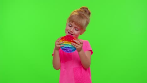 Child-girl-kid-playing-squeezing-anti-stress-pop-it-touch-screen-toys-simple-dimple-game,-chroma-key