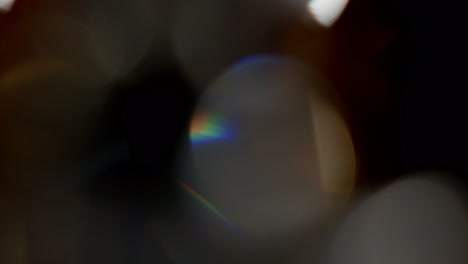 Multicolored-light-leaks-footage-on-black-background,-lens-flare-leak-burst-overlays-transitions
