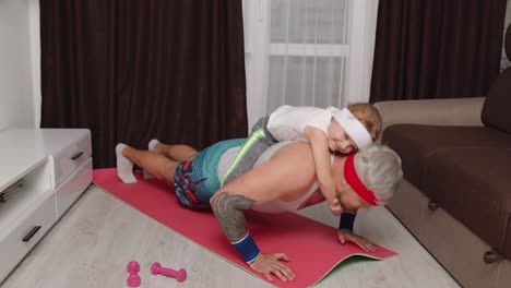 Sportsman-man-working-out-with-child-kid-girl,-push-ups-exercises-with-daughter-lying-on-his-back