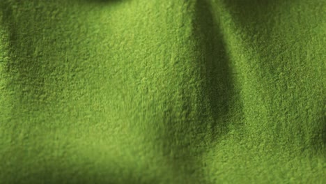 Highly-detailed-green-cloth-fabric-fluttering-on-the-wind.-Textile-surface-with-fiber-pattern-visible-in-close-up-camera.-Natural,-smooth-drapery-movement.-Endless,-seamless,-loopable-animation.
