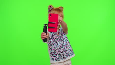 Happy-funky-blogger-child-kid-girl,-recording-funny-dancing-video-on-smartphone-for-social-network