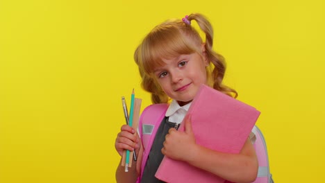 Funny-positive-kid-primary-school-girl-with-ponytails-wearing-uniform-smiling-on-yellow-background