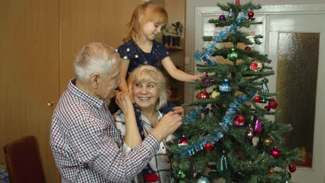 Kinder,-Mädchen-Mit-Großeltern,-Paar-Schmücken-Künstlichen-Weihnachtsbaum-Im-Altmodischen-Zuhause