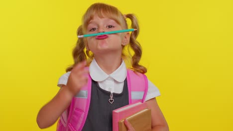 Funny-joyful-kid-primary-school-girl-making-playful-silly-facial-expressions-fooling-around-with-pen