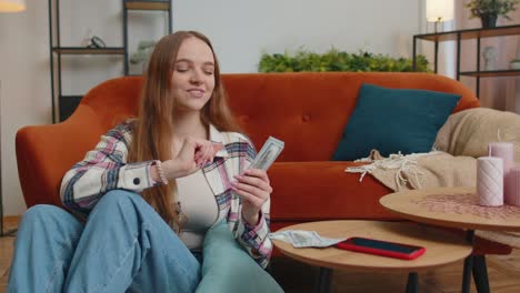 Smiling-happy-young-woman-counting-money-cash,-calculate-domestic-bills-at-home-satisfied-of-income