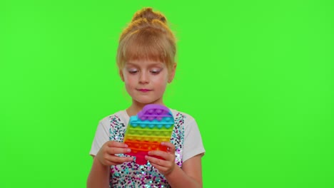 Stylish-cute-little-child-kid-play-with-trendy-pop-it-bubble-squishy-sensory-toy-game-on-chroma-key