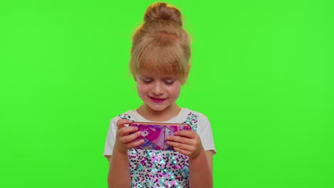 Child-girl-kid-loses-on-mobile-phone-game,-use-squishy-silicone-anti-stress-pop-it-toy-to-calm-down