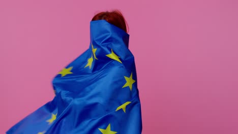 Pretty-teen-girl-waving-European-Union-flag,-smiling,-cheering-democratic-laws-human-rights-freedoms
