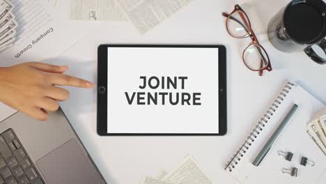 Joint-Venture-Wird-Auf-Einem-Tablet-Bildschirm-Angezeigt
