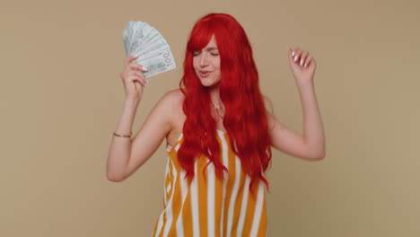 Redhead-girl-holding-cash-money-dollar-celebrate-dance,-success-business-career,-lottery-game-winner