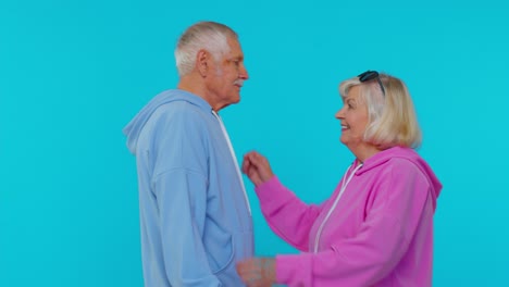 Romantic-senior-couple-man-woman-grandparents-hugging,-embracing,-looking-at-camera-and-smiling