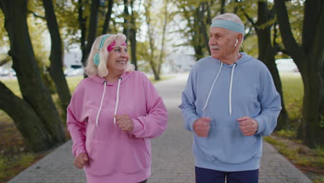 Athletic-fitness-senior-elderly-sport-runner-man-woman-training-cardio-workout-in-park-at-morning
