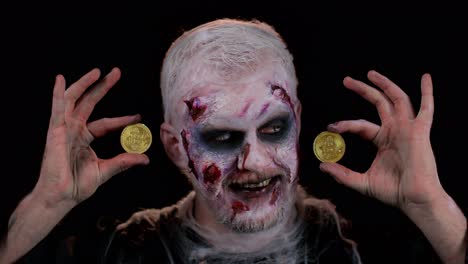 Creepy-man-with-bloody-scars-face,-Halloween-zombie-showing-golden-bitcoins-mining-future-technology