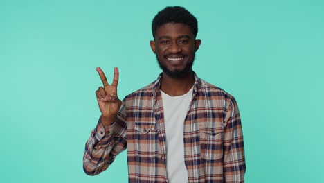 African-american-smiling-man-showing-victory-sign,-hoping-for-success-and-win,-doing-peace-gesture